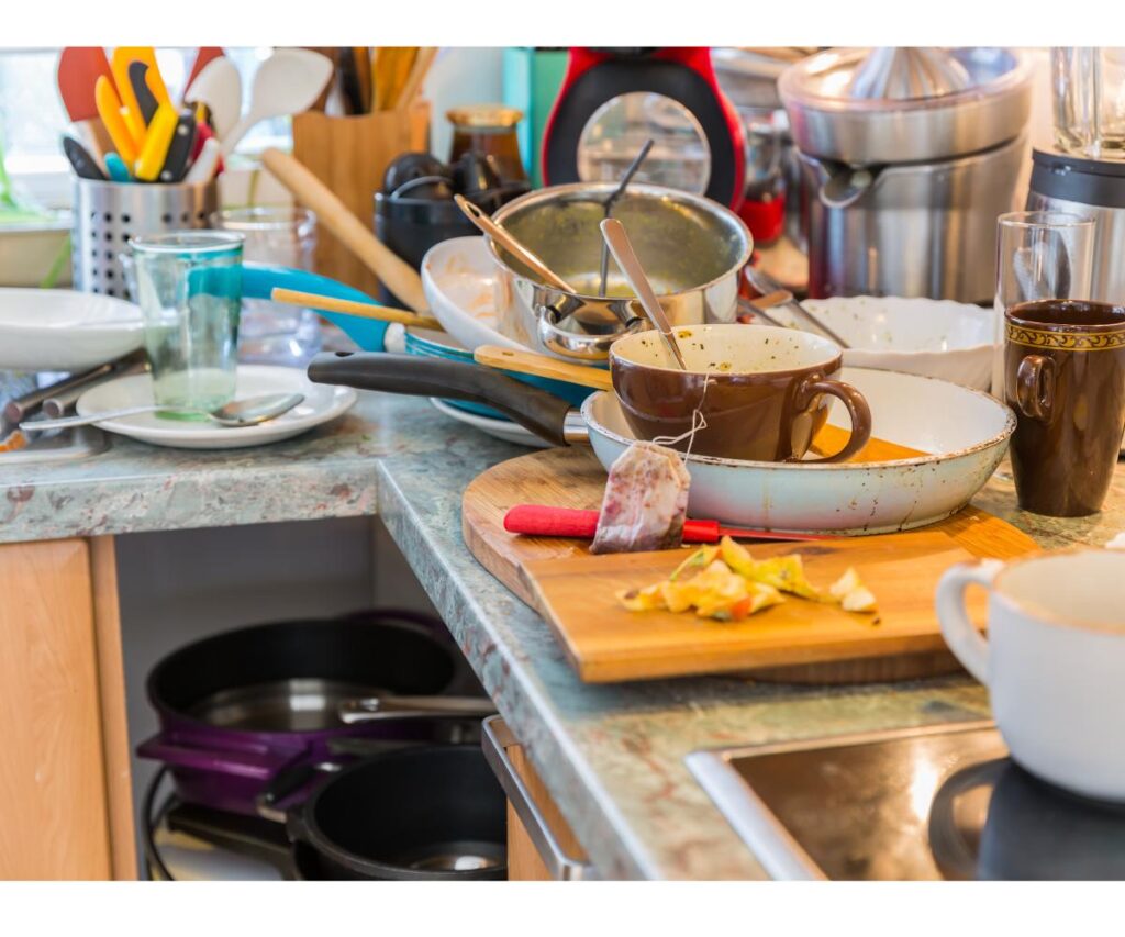 dirty dishes with food on a kitchen counter.